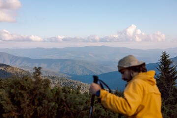 blurred silhouette of a traveler on the background of evening mountain landscapes