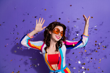 Photo of positive glamour lady wear stylish clothes raise hands enjoy good mood weekend friday disco isolated on purple color background