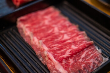 Close up of sliced raw meat, ready to be cooked by hot pot