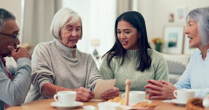 Asian family, memory and pictures with parents, grandmother and hug with coffee break, table and home. Senior man, elderly mother and daughter with photos, conversation and nostalgia at breakfast