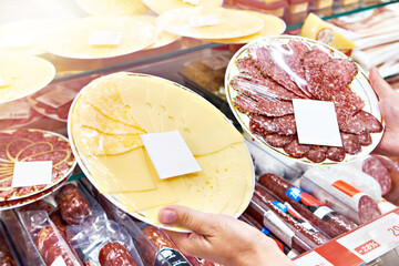 Sliced cheese and sausage in store