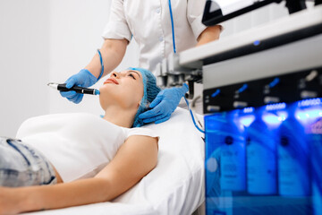 Facial treatment. Nice young woman lying on the medical bed while having a beauty procedure