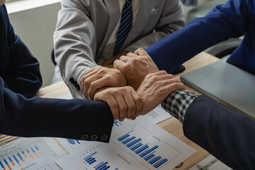 A group of business people join hands to successfully make contact, work as a team to achieve goals, hand-to-hand coordination is a symbol of unity within the organization to strive for success.