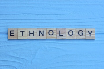 word ethnology made from wooden gray letters lies on a blue background