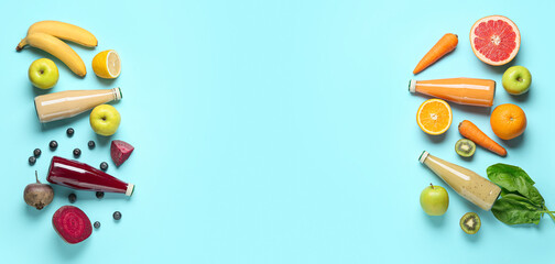 Bottles of healthy smoothies and ingredients on light blue background with space for text