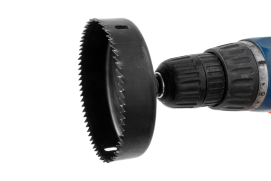 hole saw with attachment on an electric screwdriver, for drilling round holes in furniture or drywall, isolated, cut out