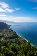 Fototapeta premium Madeira coast side with green fields in front of Atlantic Ocean on a beautiful sunny day