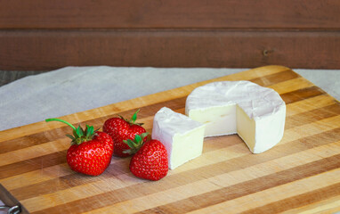 Camembert cheese with  strawberries. Selective focus.