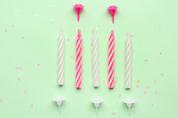 Birthday candles on green background