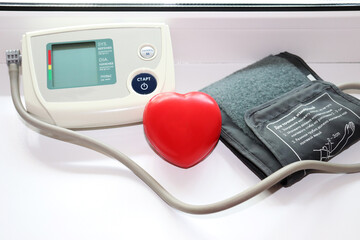 automatic portable blood pressure monitor - turned off device by the window and rubber hand trainer...