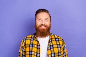 Portrait of red hair bearded young guy looking up empty space wear plaid shirt clothes isolated purple color background