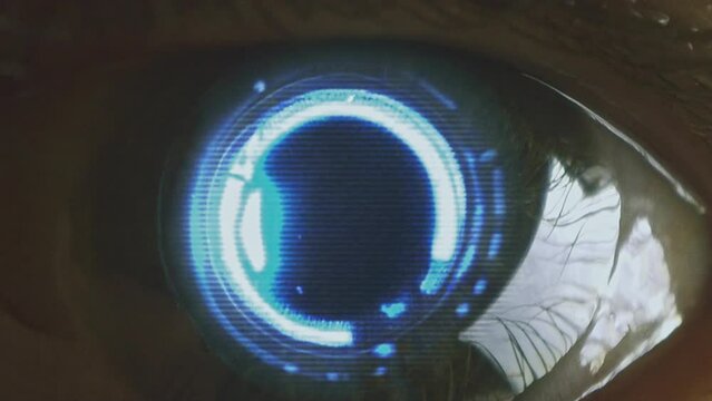 Large robotic android eye with a glowing cybernetic iris staring at the camera. Macro, close-up. Loop. Looping footage. Sci fi, science fiction cinematic video. Artificial intelligence concept.