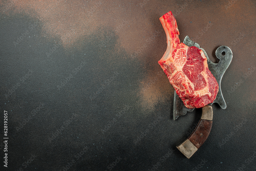 Wall mural tomahawk steak. raw beef meat. place for text, top view