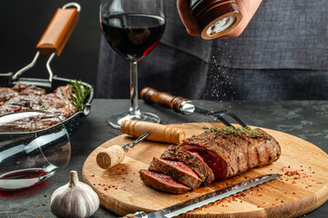 dinner steaks and red wine on a dark background, place for text, top view