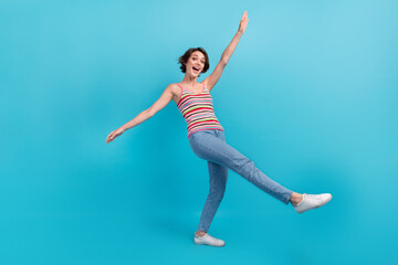 Fototapeta na wymiar Full size photo of cheerful overjoyed girl enjoy dancing partying good mood isolated on blue color background