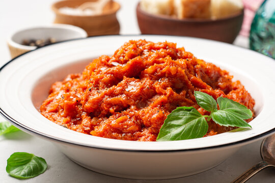 Pappa al Pomodoro. Tuscan bread soup with tomatoes, olive oil and basil in plate on concrete background. Traditional italian dish.