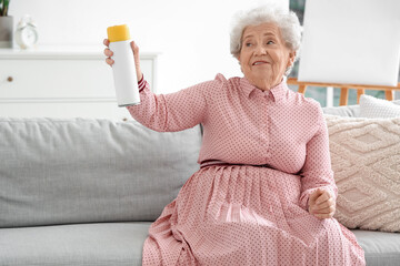 Senior woman with air freshener at home