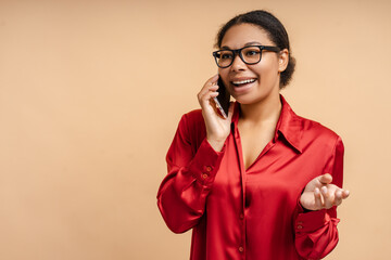 Portrait of smiling beautiful african american businesswoman talking on mobile phone, answering call looking away on isolated background. Successful business concept 