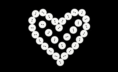 Heart from white buttons on a black background. Love, romantic