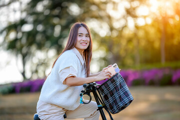 Asian woman riding a bicycle at the park