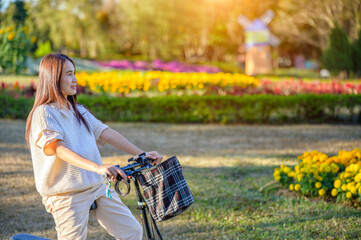 Asian woman riding a bicycle at the park