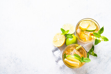 Iced tea with lemon, lime, mint and ice.