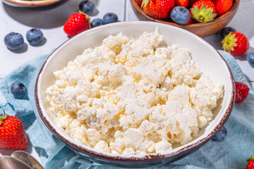 Cottage cheese with berries. Bowl of cottage cheese with strawberry, blueberry, high-protein summer healthy breakfast or lunch, copy space