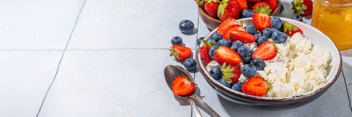 Cottage cheese with berries. Bowl of cottage cheese with strawberry, blueberry, high-protein summer healthy breakfast or lunch, copy space