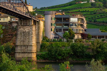 Sunset above the bridge and grape vines in the Douro Valley Portugal at the beginning of summer