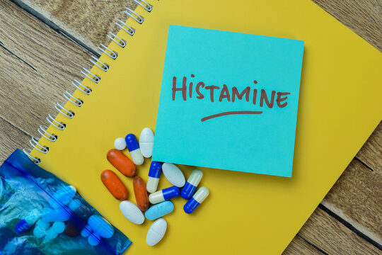 Concept of Histamine write on sticky notes isolated on Wooden Table.