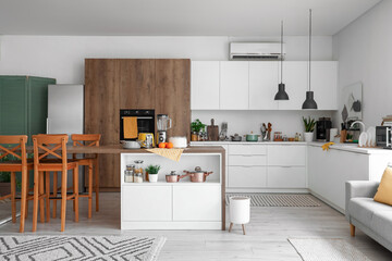 Interior of light kitchen with modern appliances on wooden table