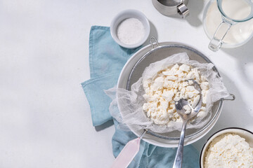 Making cottage cheese, homemade fermenting dairy product. Homemade cottage cheese in cheesecloth...