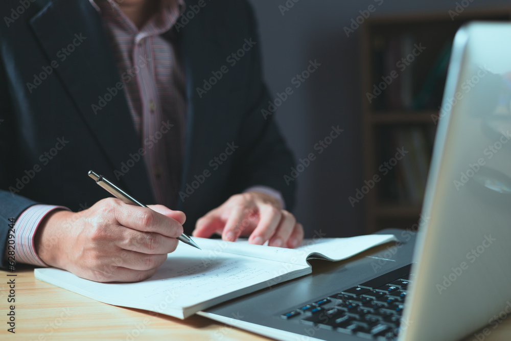 Poster man using smartphone and taking notes in planning. which is payment online, sits on the chair in the