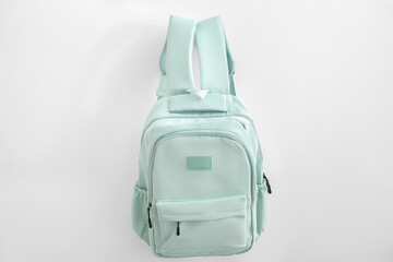 Green school backpack on white background