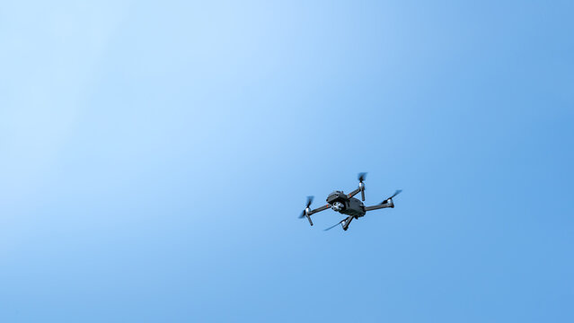 A surveillance drone in front of blue sky