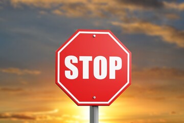 A red alarm stop sign at blue sky background