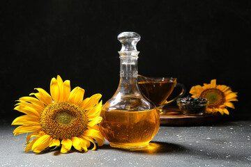 Decanter of sunflower oil on black background