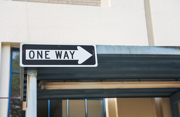 one-way sign on a city street, symbolizing direction, restriction, and adherence to a predefined...