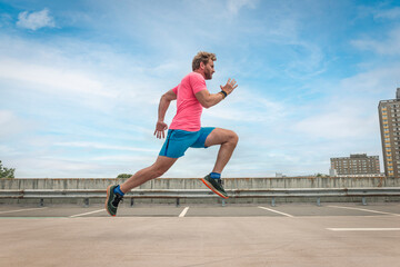 Fit sporty man running, urban background