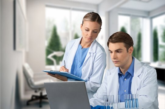 Team of doctors work with laptop in modern hospital, AI generated image