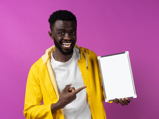 Cheerful black man standing and showing mini whiteboard