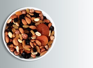 mixed tasty nuts in bowl on the desk