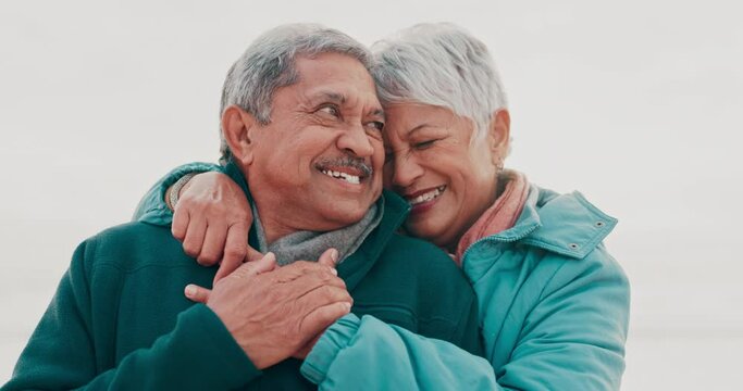 Hug, happy and senior couple at a beach for intimacy, bond and traveling together. Love, smile and old people embrace sweet moment at the sea enjoying relationship, retirement and travel freedom