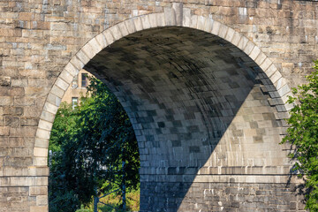 Close up of an arch under section of a bridge.