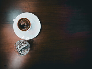 Cup with coffee on white background. Latte art of heart design on coffee. Top view.