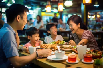 Selbstklebende Fototapete Bangkok Asian family dining at busy street food restaurant in Bangkok, Thailand