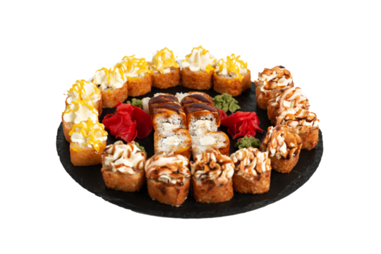 sushi set. different types of sushi on a big round black dish. Sushi set on a black slate.