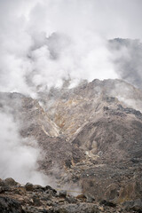 Wisps of smoke around the crater scattered rocks