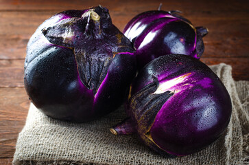 Fresh Eggplants over Wooden Rustic Background, Purple Round Eggplants
