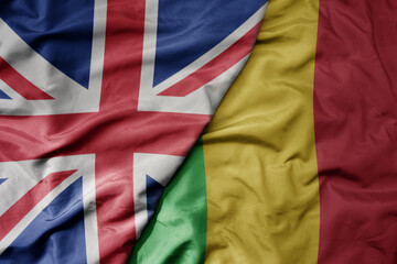 big waving national colorful flag of great britain and national flag of mali .